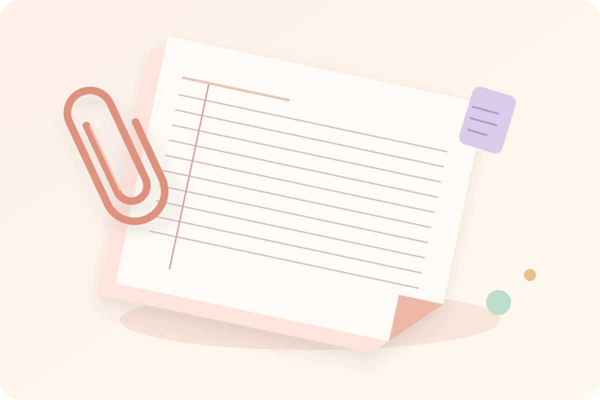 Peach folded stationery seen from above at an angle, with a coral paperclip and soft horizontal rules